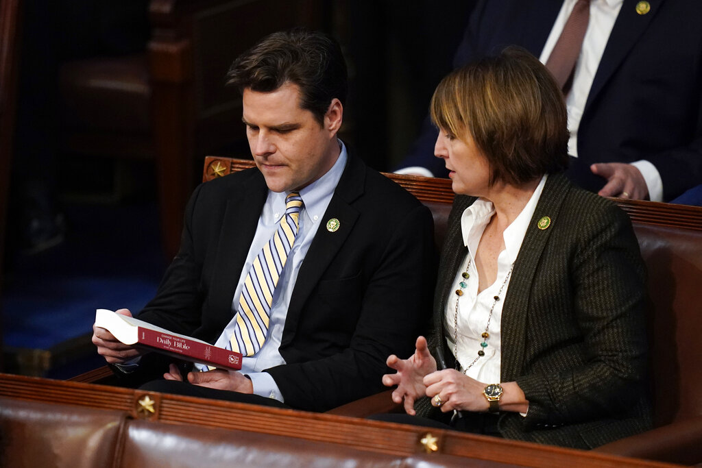 Rep. Cathy McMorris Rodgers, R-Wash., right, hands a copy of the Daily Bible to Rep. Matt Gaetz, R-Fla., during the ninth vote in the House chamber as the House meets for the third day to elect a speaker and convene the 118th Congress in Washington, Thursday, Jan. 5, 2023.