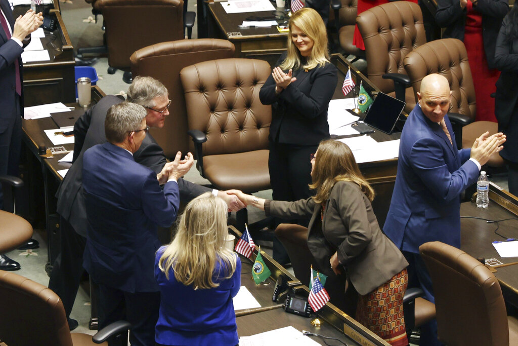 House Republican leader J.T. Wilcox shakes hands with Rep Tana Senn after addressing legislators on the first day of the legislative session at the Washington state Capitol in Olympia, Wash., on Monday, Jan. 9, 2023.