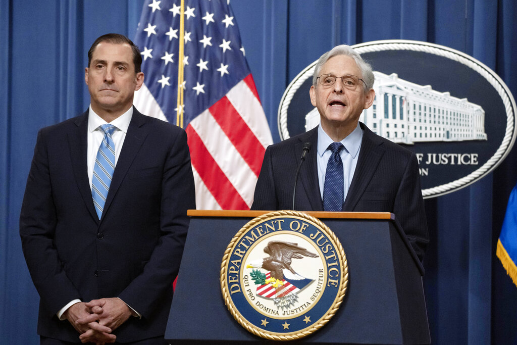 Attorney General Merrick Garland speaks during a news conference at the Department of Justice, Thursday, Jan. 12, 2023, in Washington, as John Lausch, the U.S. Attorney in Chicago, looks on.