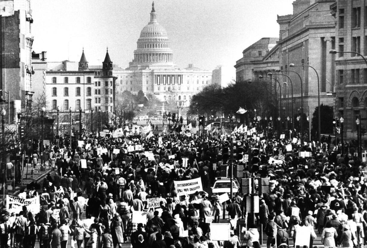 FILE - Several thousand marchers, protesting the 8-year-old Supreme Court decision permitting abortions, march down Pennsylvania Avenue in Washington toward the U.S. Capitol building, Jan. 22, 1981. Anti-abortion activists will have multiple reasons to celebrate – and some reasons for unease -- when they gather Friday, Jan. 20, 2023 in Washington for the annual March for Life. The march has been held since January 1974 – a year after the U.S. Supreme Court’s Roe v. Wade decision established a nationwide right to abortion. (AP Photo/Herbert K.