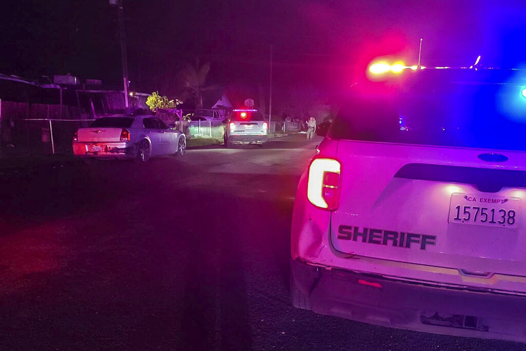 In this image released by Tulare County Sheriff's Office, detectives investigate a shooting in Goshen near Visalia, Calif., early morning Monday, Jan. 16, 2023. Sheriff's officials say six people including a 17-year-old mother and her 6-month-old baby were killed in a shooting early Monday at the home in central California, and authorities are searching for at least two suspects.