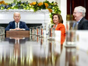 FILE - President Joe Biden, left, accompanied by House Speaker Nancy Pelosi of Calif., second from right, and Senate Minority Leader Mitch McConnell of Ky., right, speaks at the top of a meeting with congressional leaders to discuss legislative priorities for the rest of the year, Nov. 29, 2022, in the Roosevelt Room of the White House in Washington.  By temperament and manner, Joe Biden and Mitch McConnell are decidedly mismatched. But as the days of divided government under Biden begin, their long relationship will become even more vital.