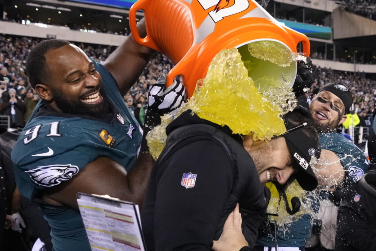 Philadelphia Eagles head coach Nick Sirianni, center, is doused by defensive tackle Fletcher Cox (91) and teammates during the second half of the NFC Championship NFL football game between the Philadelphia Eagles and the San Francisco 49ers on Sunday, Jan. 29, 2023, in Philadelphia.