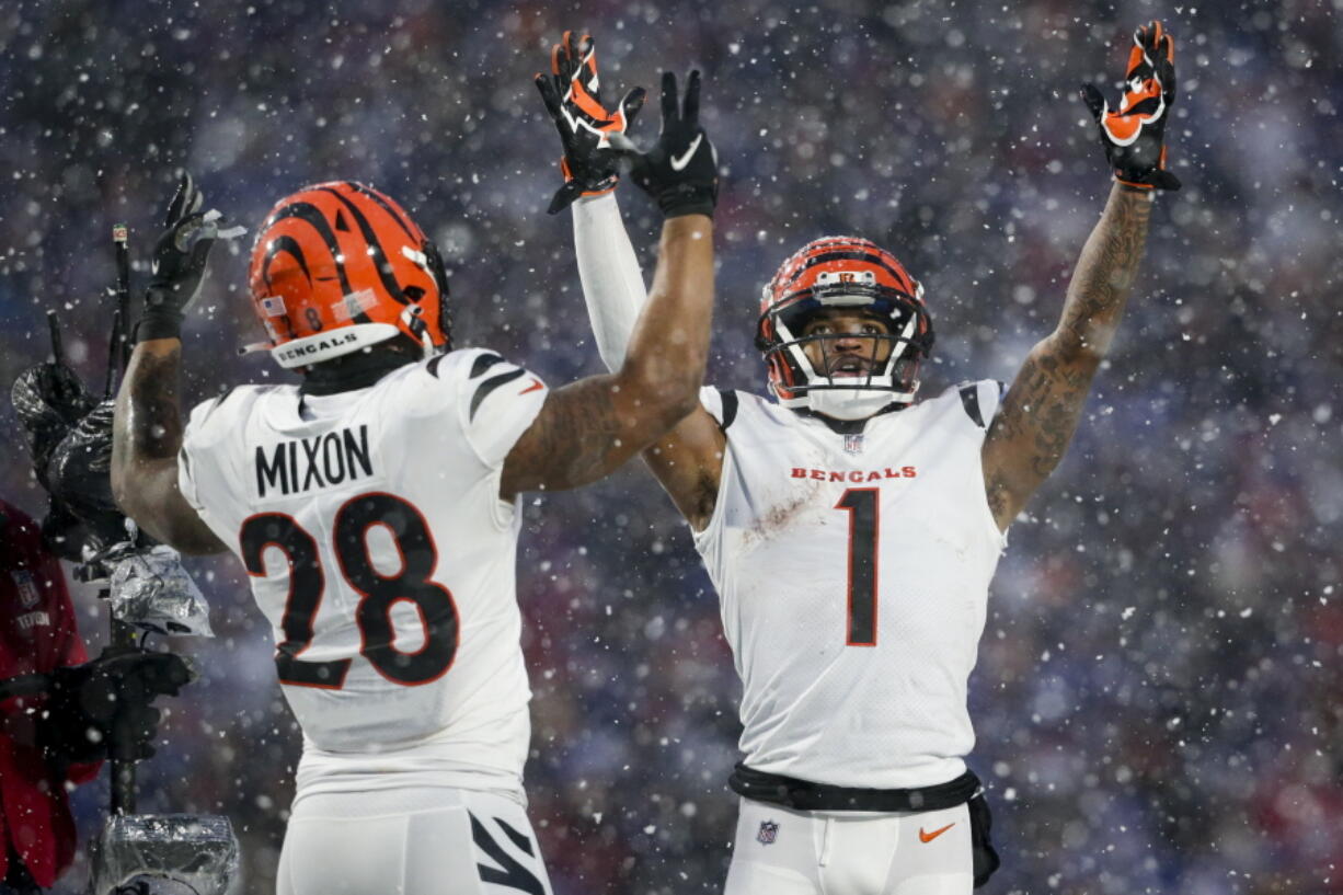 Cincinnati Bengals wide receiver Ja'Marr Chase (1) and running back Joe Mixon celebrate touchdown against the Buffalo Bills on Sunday in Orchard Park, N.Y.