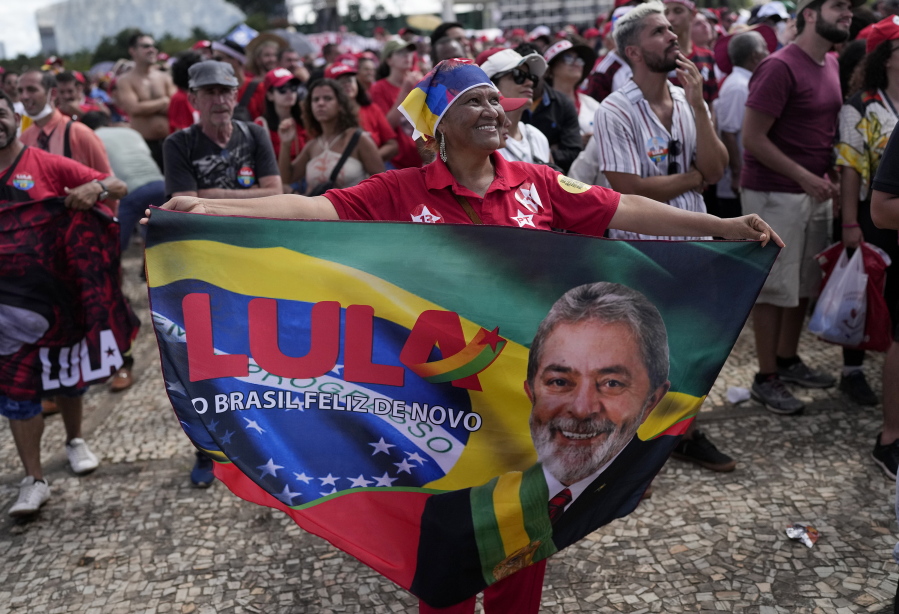 A supporter of Luiz Inacio Lula da Silva displays a banner during his inauguration as new president outside the Planalto presidential palace in Brasilia, Brazil, Sunday, Jan. 1, 2023.