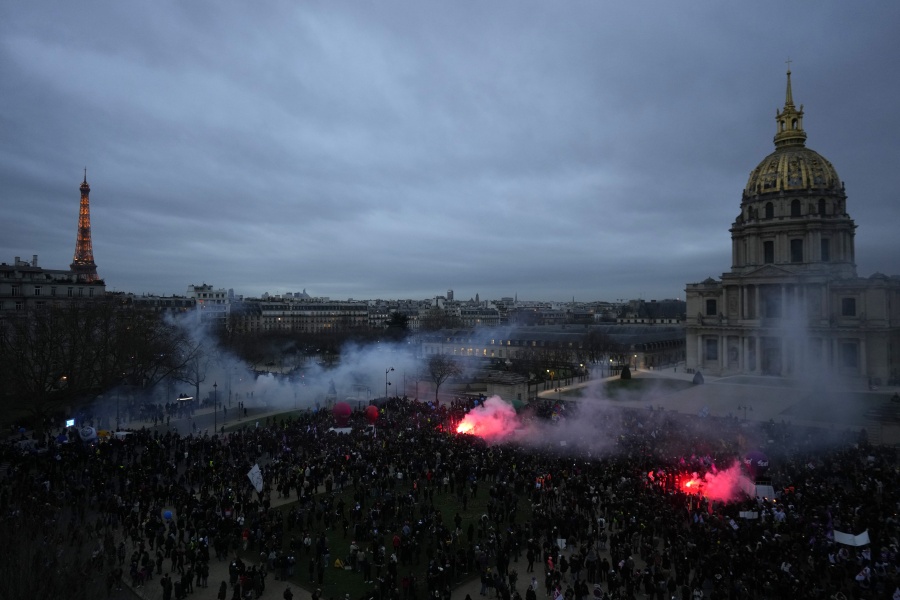 Protestors end the demonstration against plans to push back France's retirement age, at the Invalides monument, right, and the Eiffel Tower in background, Tuesday, Jan. 31, 2023 in Paris. Labor unions aimed to mobilize more than 1 million demonstrators in what one veteran left-wing leader described as a "citizens' insurrection." The nationwide strikes and protests were a crucial test both for President Emmanuel Macron's government and its opponents.