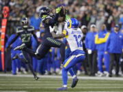 Seattle Seahawks safety Quandre Diggs (6) intercepts a pass intended for Los Angeles Rams wide receiver Van Jefferson (12) during the overtime of an NFL football game Sunday, Jan. 8, 2023, in Seattle.