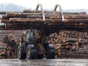 FILE - In this Feb. 26, 2015 photo, a front end log loader transports logs at Swanson Group Manufacturing in Roseburg, Ore. In Oregon, mass timber is increasingly being viewed as a construction material that could help the state build more affordable homes and revive rural logging towns. A new prototype of a mass timber affordable housing unit was unveiled at the Port of Portland on Friday, Jan. 27, 2023.