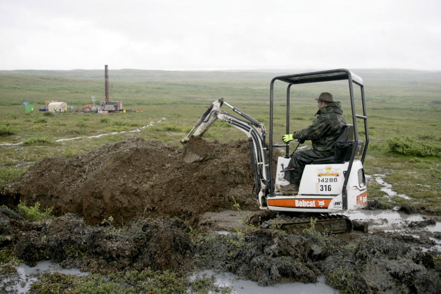 FILE - A worker with the Pebble Mine project digs in the Bristol Bay region of Alaska near the village of Iliamma, Alaska, July 13, 2007. The U.S. Environmental Protection Agency announced a decision Tuesday, Jan. 31, 2023, that would block plans for the proposed Pebble Mine, a copper and gold project in southwest Alaska.