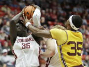 Washington State forward Mouhamed Gueye, left, grabs a rebound next to Arizona State guard Devan Cambridge during the second half of an NCAA college basketball game, Saturday, Jan. 28, 2023, in Pullman, Wash.