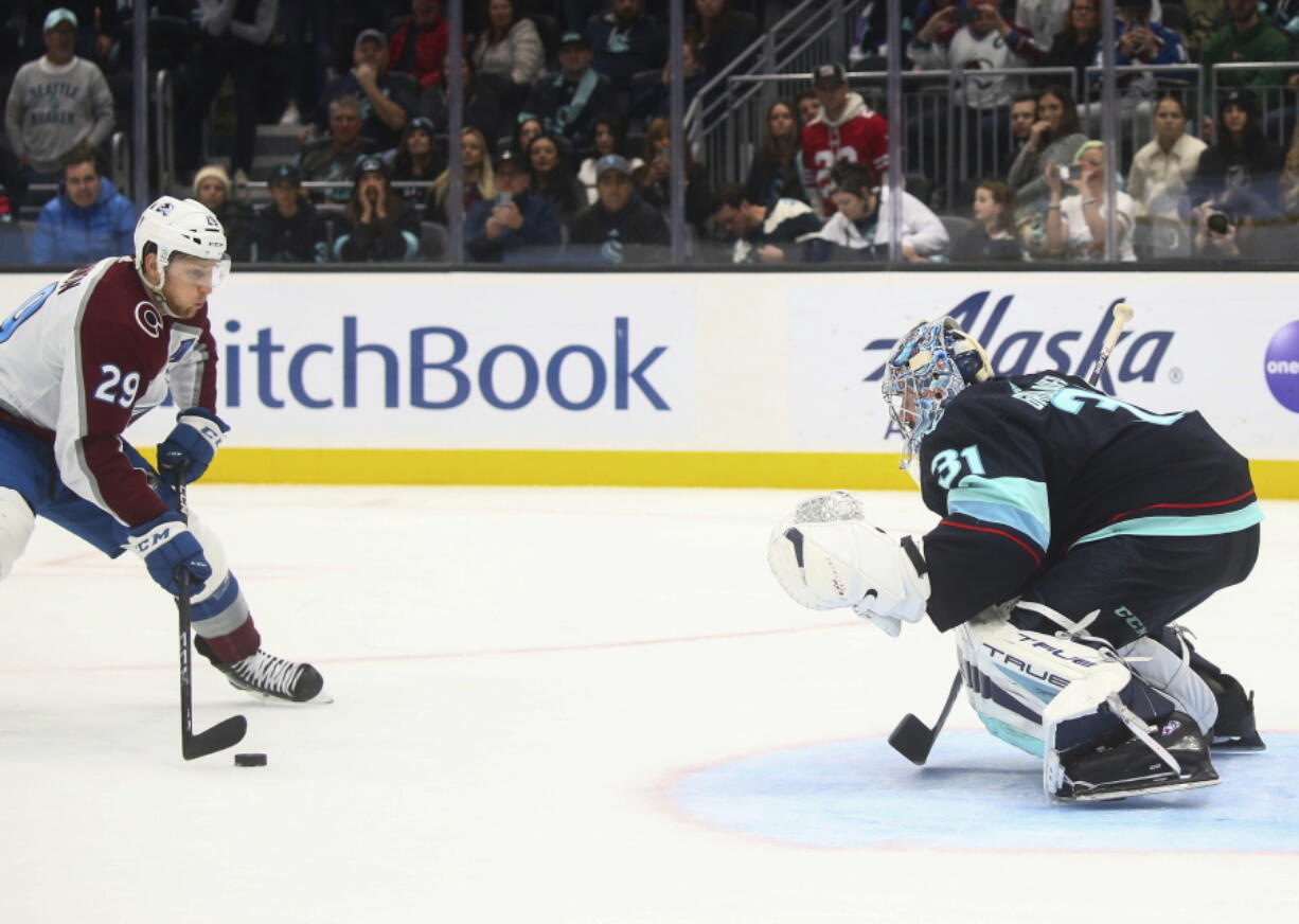 Colorado Avalanche center Nathan MacKinnon (29) prepares to shoot on Seattle Kraken goaltender Philipp Grubauer (31) for the only goal of the shootout in an NHL hockey game Saturday, Jan. 21, 2023, in Seattle. The Avalanche won 2-1.