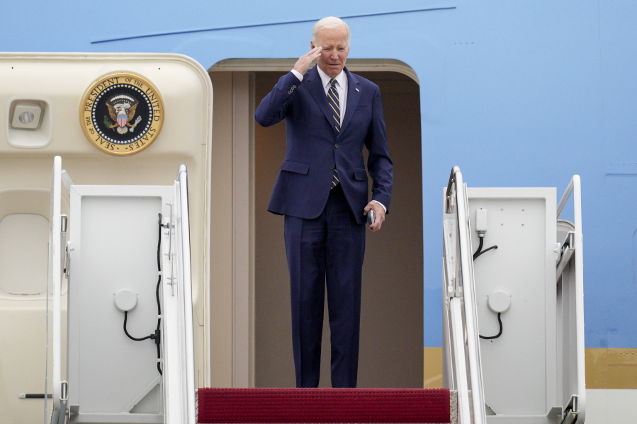 President Joe Biden returns a salute as he boards Air Force One at Andrews Air Force Base, Md., Thursday, Jan. 19, 2023, en route to California.