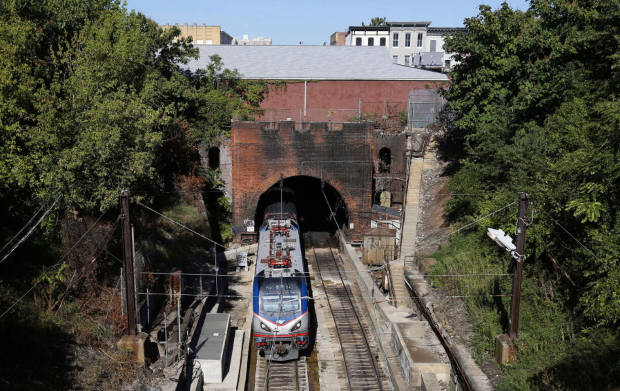 FILE - An Amtrak train emerges from the Baltimore and Potomac Tunnel in Baltimore,  Sept. 15, 2015. The tunnel is finally slated to be replaced with help from the $1 trillion bipartisan infrastructure legislation championed by Biden, and he plans to visit on Monday to talk about the massive investment.