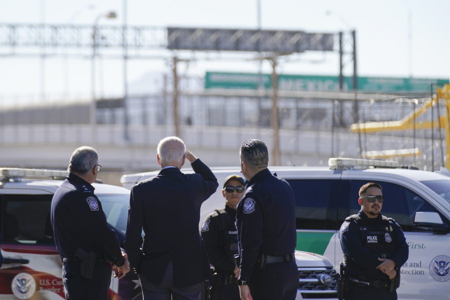President Joe Biden, second from left, looks towards a large "Welcome to Mexico" sign that is hung over the Bridge of the Americas as he tours the El Paso port of entry a busy port of entry along the U.S.-Mexico border, in El Paso Texas, Sunday, Jan. 8, 2023.