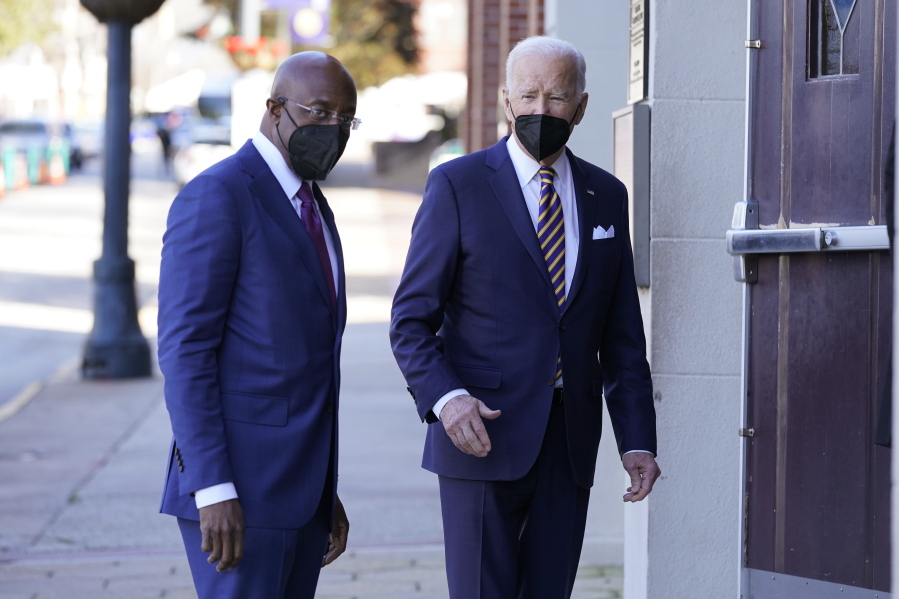 FILE - President Joe Biden and Sen. Raphael Warnock, D-Ga., enter Ebenezer Baptist Church, Jan. 11, 2022, in Atlanta. Warnock is senior pastor at the church. With Warnock having secured his first full term and Biden buoyed by Democrats' better-than-expected election results, the senator is welcoming the president back to Georgia and to America's most famous Black church.