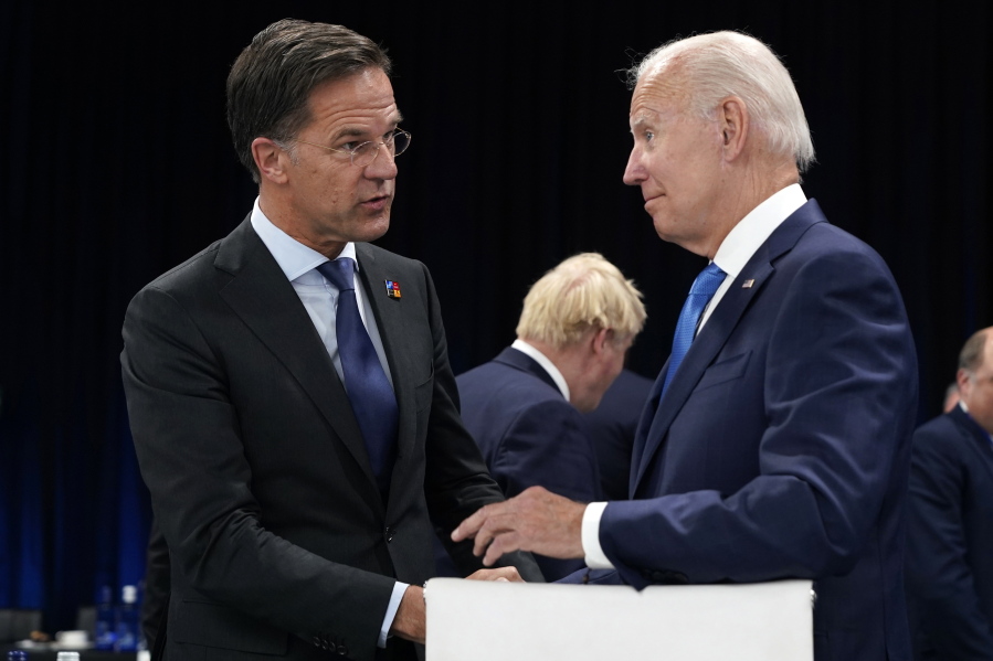 FILE - Netherland's Prime Minister Mark Rutte, left, speaks with U.S. President Joe Biden during a round table meeting at a NATO summit in Madrid, Spain, June 29, 2022. Biden is set to host Dutch Prime Minister Mark Rutte for talks. The U.S. administration is looking to persuade the Netherlands to further limit China's access to advanced semiconductors with export restrictions.