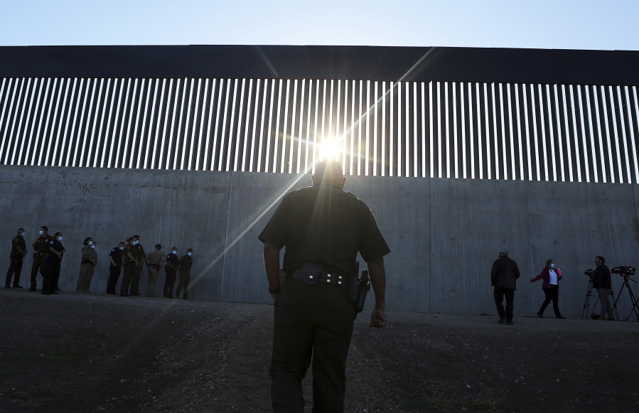 A U.S. Border Patrol agent walk up to a new section of the border wall before the arrival of Acting Homeland Secretary Chad Wolf Thursday, Oct. 29, 2020, in McAllen, Texas. An investigation is underway after a Texas National Guard soldier allegedly shot and wounded a migrant during a struggle on the U.S-Mexico border this month. The quiet handling of the incident has drawn criticism from a Texas lawmaker and a former head of U.S. Customs and Border Protection.