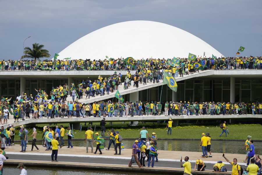 FILE - Protesters, supporters of Brazil's former President Jair Bolsonaro, storm the the National Congress building in Brasilia, Brazil, Jan. 8, 2023. Brazil's federal police searched the home of a nephew of Bolsonaro on Friday, Jan. 27, 2023, in connection with the Jan. 8 storming of government buildings in the capital by far-right protesters.