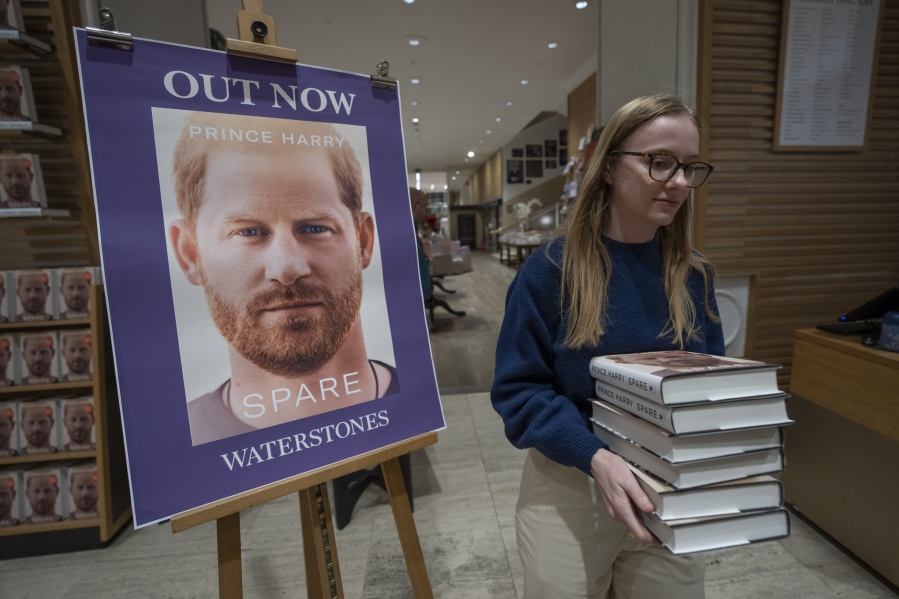A member of staff places the copies of the new book by Prince Harry called "Spare" at a book store in London, Tuesday, Jan. 10, 2023. Prince Harry's memoir "Spare" went on sale in bookstores on Tuesday, providing a varied portrait of the Duke of Sussex and the royal family.