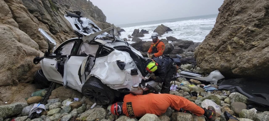 This photo provided by the San Mateo County Sheriff's Office shows emergency personnel responding to a vehicle over the side of Highway 1 on Sunday, Jan. 1, 2023, in San Mateo County, Calif. The driver of the car that plunged off a cliff in Northern California, seriously wounding two children and a second adult after the 250-foot drop, was arrested on suspicion of attempted murder and child abuse, the California Highway Patrol said Tuesday, Jan. 3. (Sgt.