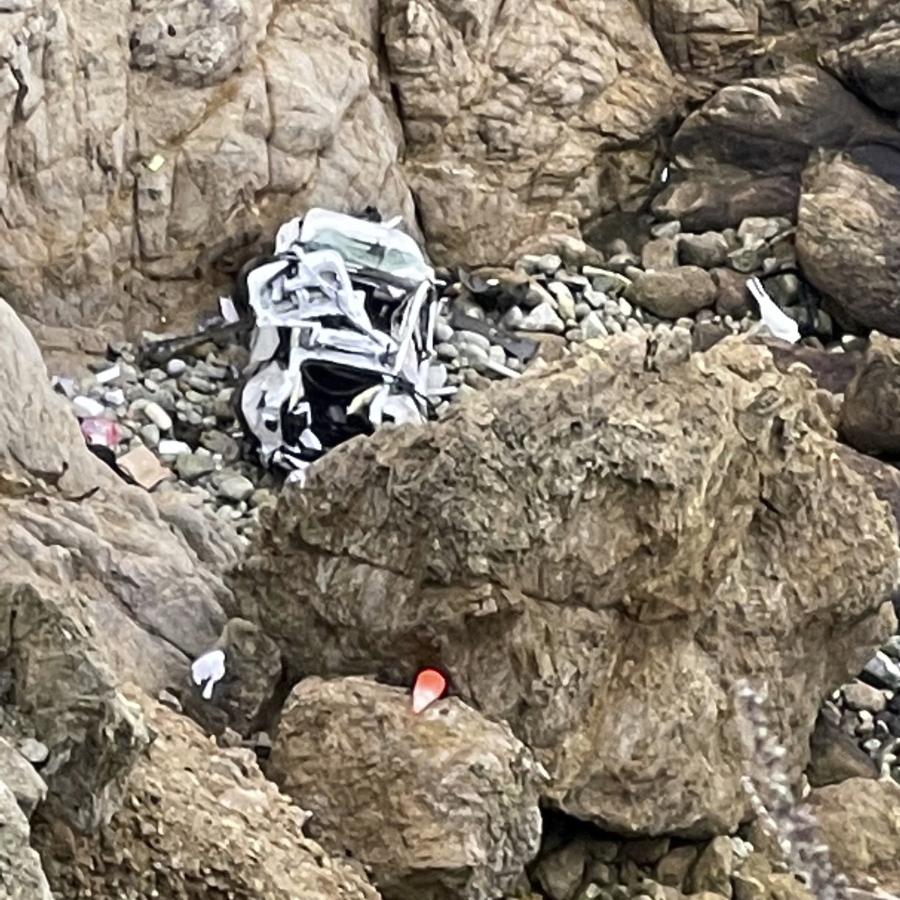 This image from video provided by San Mateo County Sheriff's Office shows a Tesla vehicle that plunged off a Northern California cliff along the Pacific Coast Highway, Monday, Jan. 2, 2023, near an area known as Devil's Slide, leaving four people in critical condition, a fire official said. The vehicle fell about 250 feet (76.20 meters) from the highway, the fire official said. Motorists were told to expect delays as rescuers worked. Helicopters were expected to transport four people to hospitals.
