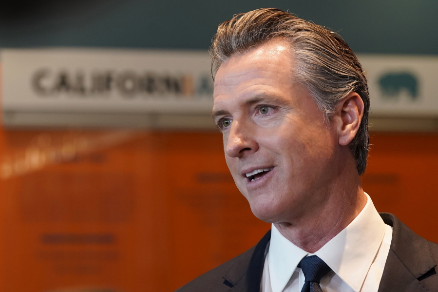 FILE - California Gov. Gavin Newsom talks to reporters after voting in Sacramento, Calif., Nov. 8, 2022. Newsom will be inaugurated for his second and final term Friday, Jan. 6. He chose the date to stand in contrast to the insurrection at the U.S. Capitol on Jan. 6, 2021.