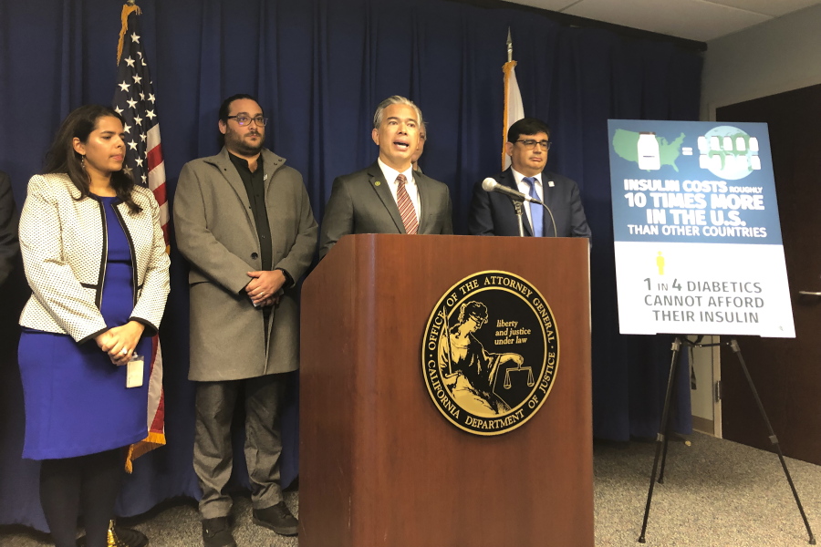 California Attorney General Rob Bonta, middle, speaks at a news conference in Sacramento, Calif., on Thursday, Jan. 12, 2023. Bonta announced a lawsuit accusing multiple companies that make or promote insulin of keeping prices too high.