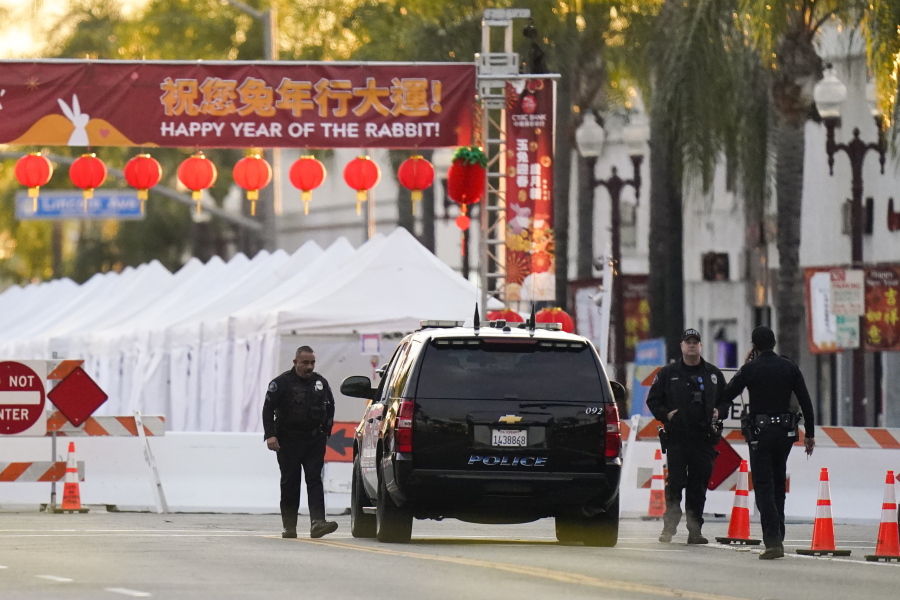Police officers stand outside a ballroom dance club in Monterey Park, Calif., Sunday, Jan. 22, 2023. A mass shooting took place at a dance club following a Lunar New Year celebration, setting off a manhunt for the suspect. (AP Photo/Jae C.