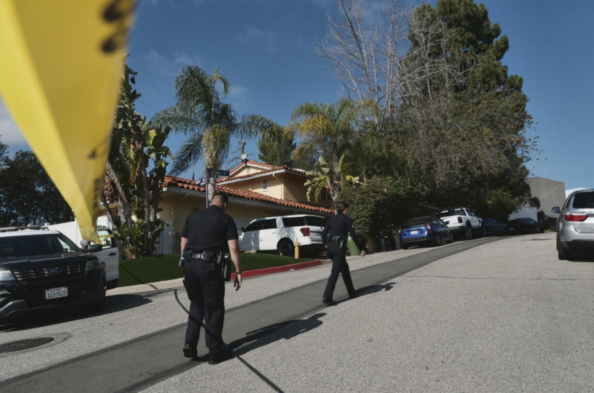Police block the street to a house where three people were killed and four others wounded in a shooing at a short-term rental home in an upscale Los Angeles neighborhood on Saturday Jan. 28, 2023. The shooting occurred about 2:30 a.m. in the Beverly Crest neighborhood.