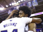 Washington forward Keion Brooks hugs guard Noah Williams after after the team's overtime win against California in an NCAA college basketball game Saturday, Jan. 14, 2023, in Seattle.