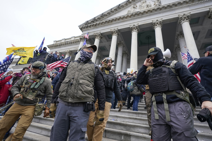 FILE - Members of the Oath Keepers extremist group stand on the East Front of the U.S. Capitol on Jan. 6, 2021, in Washington. The Capitol riot was the culmination of weeks of preparation and a moment of triumph for the Oath Keepers, federal prosecutor Louis Manzo said Jan. 18, 2023, in closing arguments in the second seditious conspiracy trial against members of the far-right extremist group. The defendants facing jurors in the latest trial are Joseph Hackett, Roberto Minuta, David Moerschel, and Edward Vallejo.