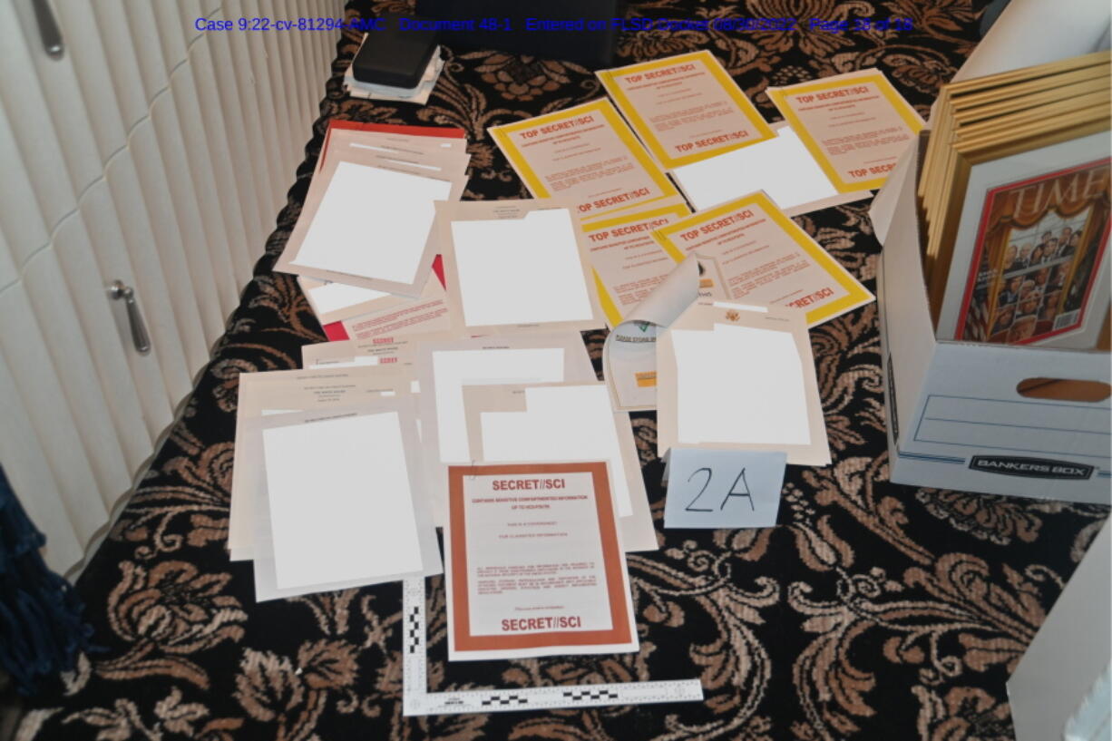FILE - This image contained in a court filing by the Department of Justice on Aug. 30, 2022, and redacted by in part by the FBI, shows a photo of documents seized during the Aug. 8 search by the FBI of former President Donald Trump's Mar-a-Lago estate in Florida. The discovery of classified documents at the home of former Vice President Mike Pence is scrambling the blame game in Washington. Now, lawmakers from both parties seem united in frustration with the string of mishaps in the handling of the U.S.