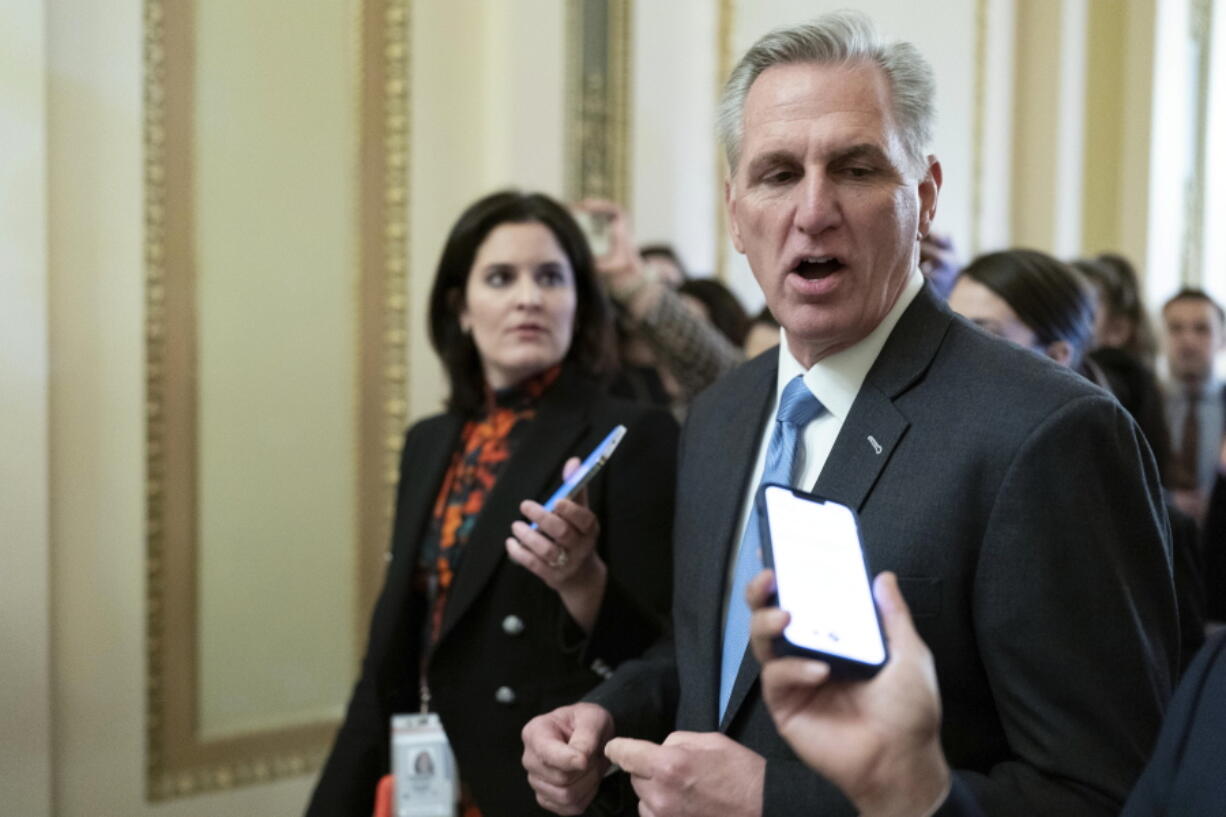 Speaker of the House Kevin McCarthy, R-Calif., talks to reporters as he walks to the House chamber at the Capitol in Washington, Monday, Jan. 9, 2023.