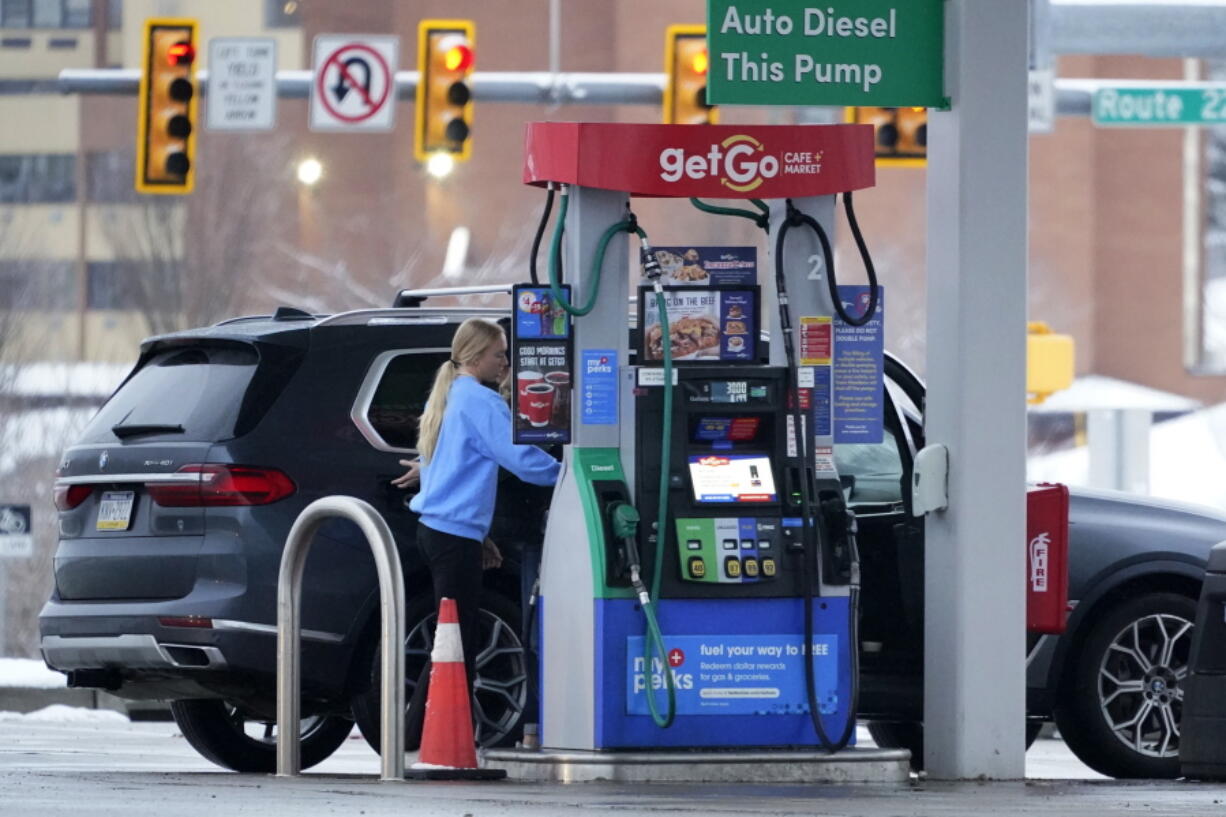 A woman pumps gas at a GetGo Mini Mart in Valencia, Pa., on Monday, Jan. 23, 2023. On Tuesday, the Conference Board reports on U.S. consumer confidence for January. (AP Photo/Gene J.
