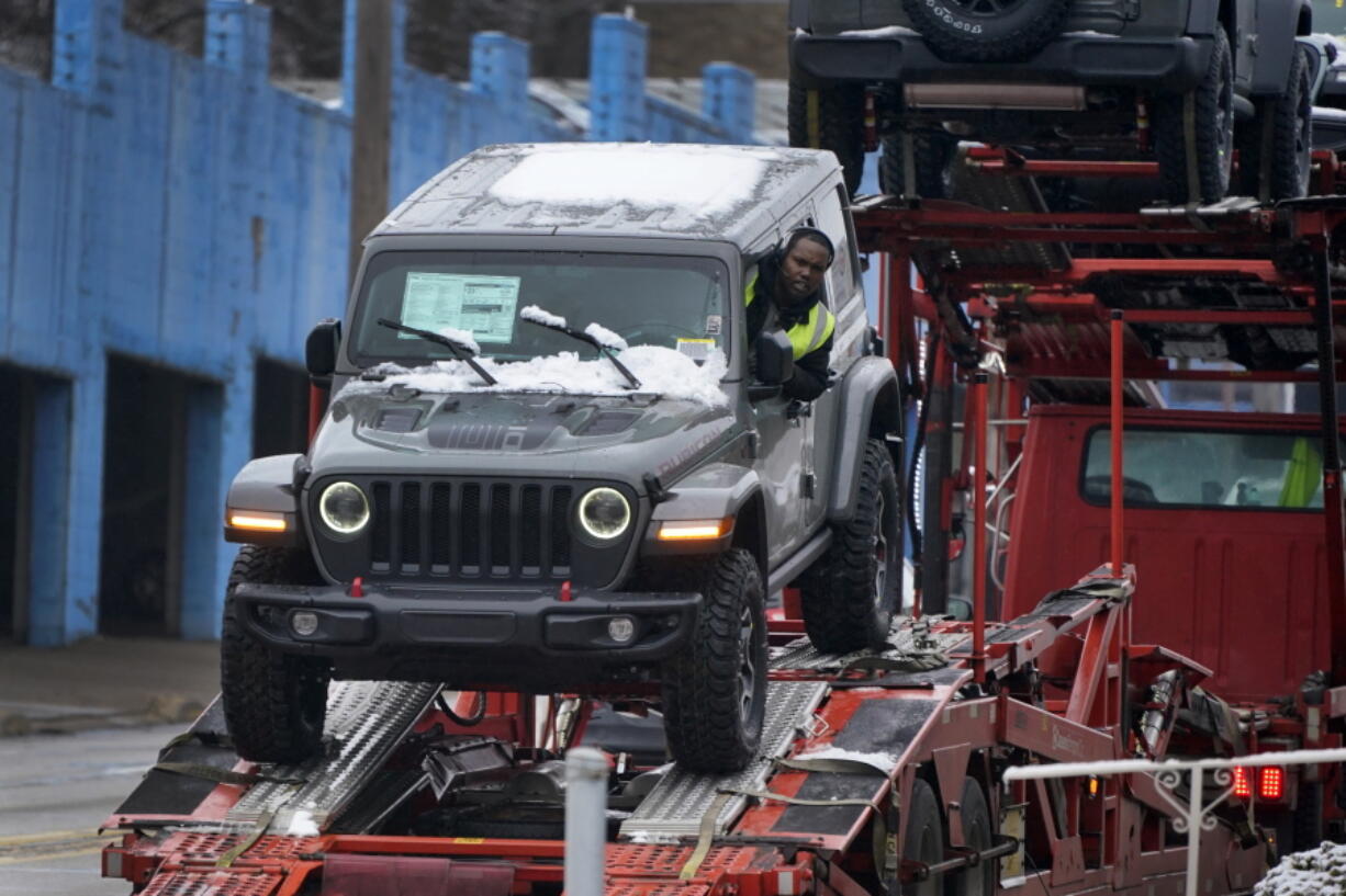 A new Jeep is delivered to a dealership in Pittsburgh on Monday, Jan. 23, 2023. On Friday, the Commerce Department issues its December report on consumer spending. (AP Photo/Gene J.