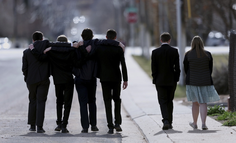 A group of young people walk away following graveside services of the Haight and Earl families in La Verkin, Utah, on Friday, Jan. 13, 2023, in La Verkin, Utah. Tausha Haight, her mother, Gail Earl, and her five children were shot and killed by her husband Jan. 4.