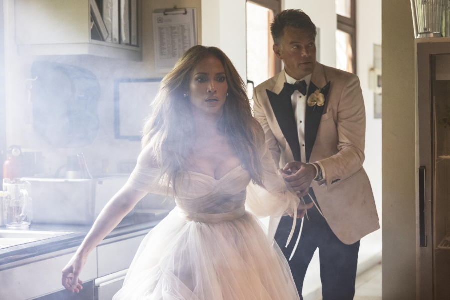 This image released by Lionsgate shows Jennifer Lopez, left, and Josh Duhamel in a scene from "Shotgun Wedding." (Ana Carballosa/Lionsgate via AP) (Lionsgate)