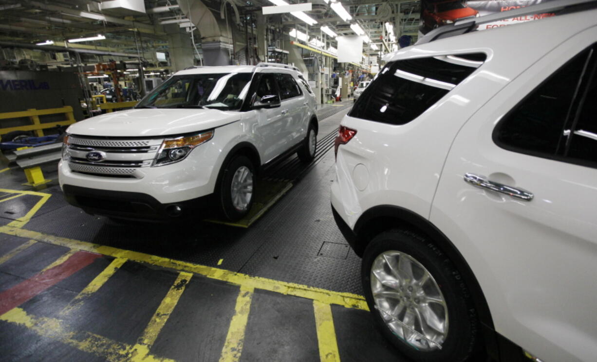 FILE - Plant employees drive 2011 Ford Explorer vehicles off the assembly line at Ford's Chicago Assembly Plant in Chicago, Dec. 1, 2010. The U.S. government's road safety agency has closed a more than six-year investigation into Ford Explorer exhaust odors, determining that the SUVs don't emit high levels of carbon monoxide and don't need to be recalled. (AP Photo/M.
