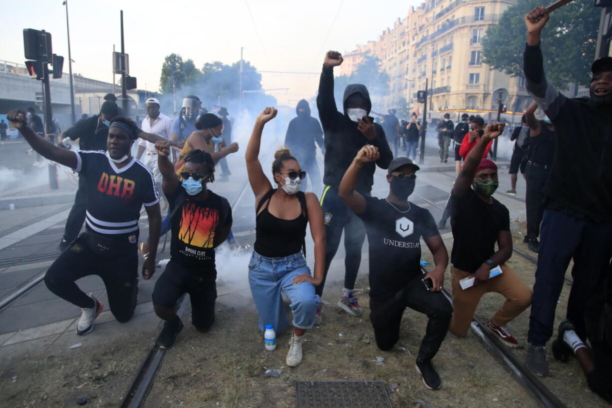 FILE- Protesters gesture during a demonstration against police violence and racial injustice, Tuesday, June 2, 2020 in Paris. French Prime Minister Elisabeth Borne announced a new plan on Monday Jan.30, 2023 to defeat long-standing racism, anti-Semitism and discrimination of all kinds in France. The four-year plan starts with educating youth with a required yearly trip to a Holocaust or other memorial site exemplifying the horrors that racism can produce and includes training teachers and civil servants about discrimination and toughening the ability to punish those denounced for discrimination.