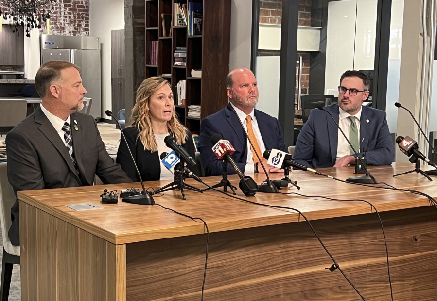 Shari Foltz, second left, speaks while her husband Cory Foltz, left, sit next to attorneys Rex Elliott, second right, and Sean Alto in a press conference where Elliott announced that the Foltz family will receive nearly $3 million from Bowling Green State University to settle its lawsuit Monday, Jan. 23 2023, in Bowling Green, Ohio. Foltz's son, Stone, died of alcohol poisoning in March 2021 after a fraternity initiation event where there was a tradition of new members finishing or attempting to finish a bottle of alcohol, according to a university investigation.