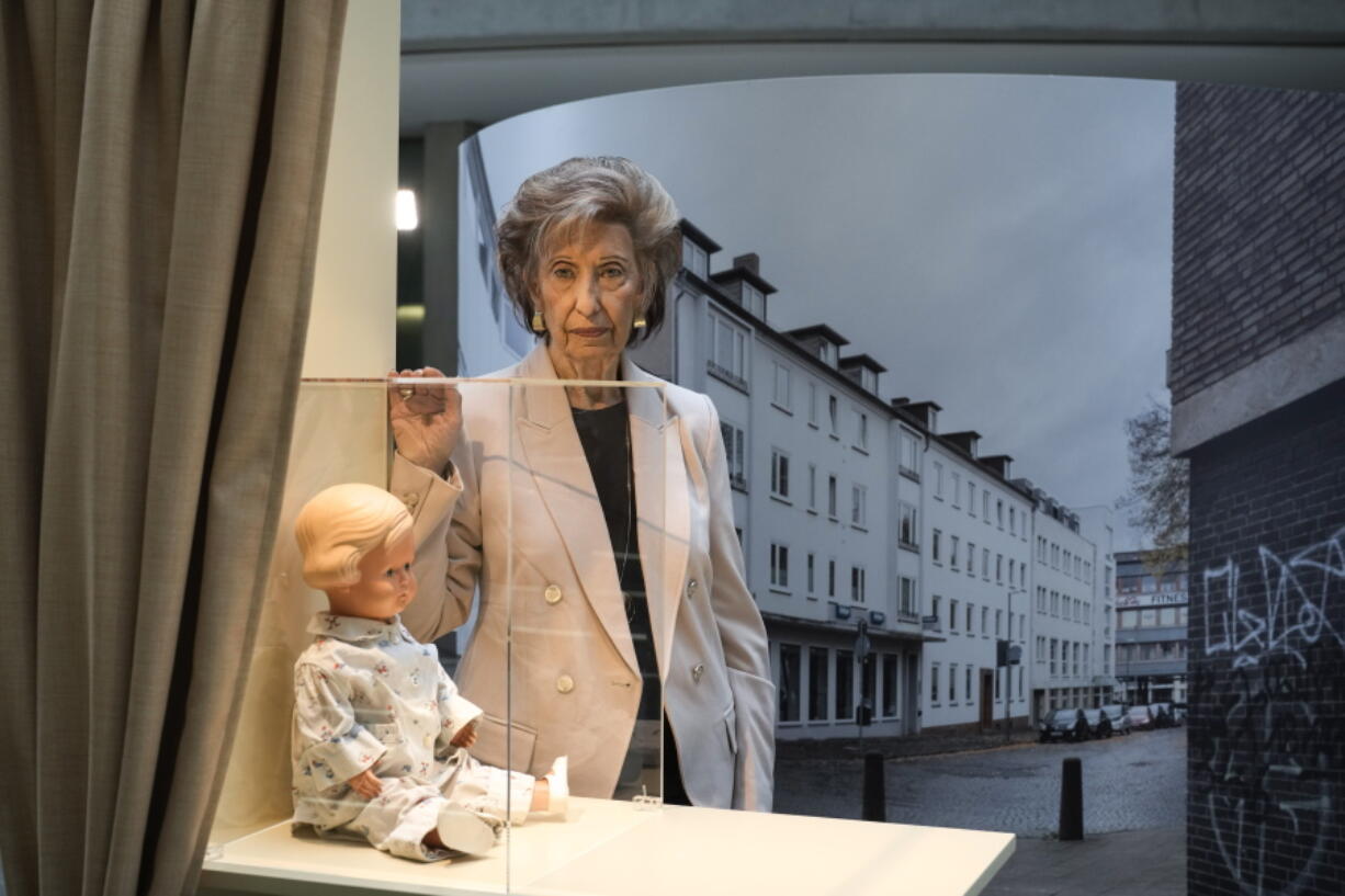 Holocaust survivor Lore Mayerfeld poses next to her doll Inge as part of an exhibition with items from Israel's Yad Vashem Holocaust memorial in the German parliament Bundestag in Berlin, Germany on Monday.