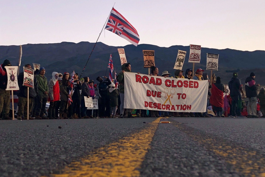 FILE - Demonstrators block a road at the base of Hawaii's tallest mountain, in Mauna Kea, Hawaii, on July 15, 2019, to protest the construction of a giant telescope on land that some Native Hawaiians consider sacred. Hawaii's new attorney general said Tuesday, Jan. 10, 2023, that several dozen elders won't be subject to another round of prosecution for blocking a road three years ago to prevent the construction of the new telescope.