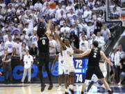 Gonzaga guard Julian Strawther (0) shoots a 3-pointer against BYU with about 10 seconds to go in an NCAA college basketball game Thursday, Jan. 12, 2023, in Provo, Utah.
