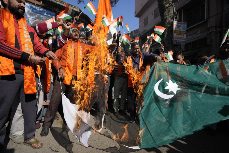 Activists of right wing Hindu groups Dogra Front and Shiv Sena, reacting to the militant attack in the southern Rajouri district of Indian-controlled Kashmir burn Pakistan flag during a protest in Jammu, India, Monday, Jan.2, 2023. Assailants sprayed bullets toward a row of civilian homes Sunday night, leaving at least four civilians dead and five others injured, police said Monday.