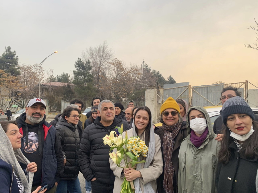 Iranian prominent actress Taraneh Alidoosti, center, holds bunches of flowers as she poses for a photo among her friends after being released from Evin prison in Tehran, Iran, Wednesday, Jan. 4, 2023. Iran released Alidoosti, a prominent actress from an Oscar-winning film, nearly three weeks after she was jailed for criticizing a crackdown on anti-government protests.