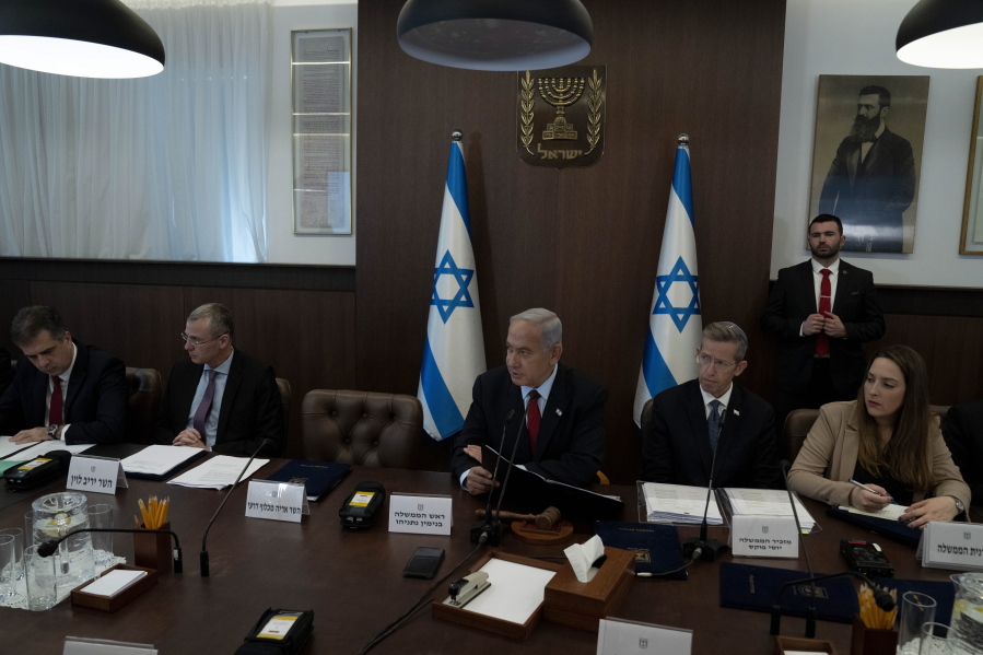 Israel's Prime Minister Benjamin Netanyahu, center, chairs the weekly cabinet meeting in Jerusalem, Sunday, Jan. 22, 2023.
