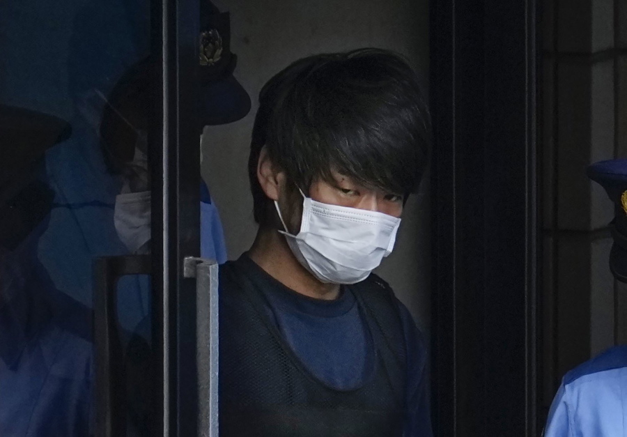 FILE - Tetsuya Yamagami, the alleged assassin of Japan's former Prime Minister Shinzo Abe, exits a police station in Nara, western Japan, on July 10, 2022, on his way to local prosecutors' office. Yamagami is expected to face murder charges Friday, Jan. 13, 2023, in Japan's highest profile case in recent years.