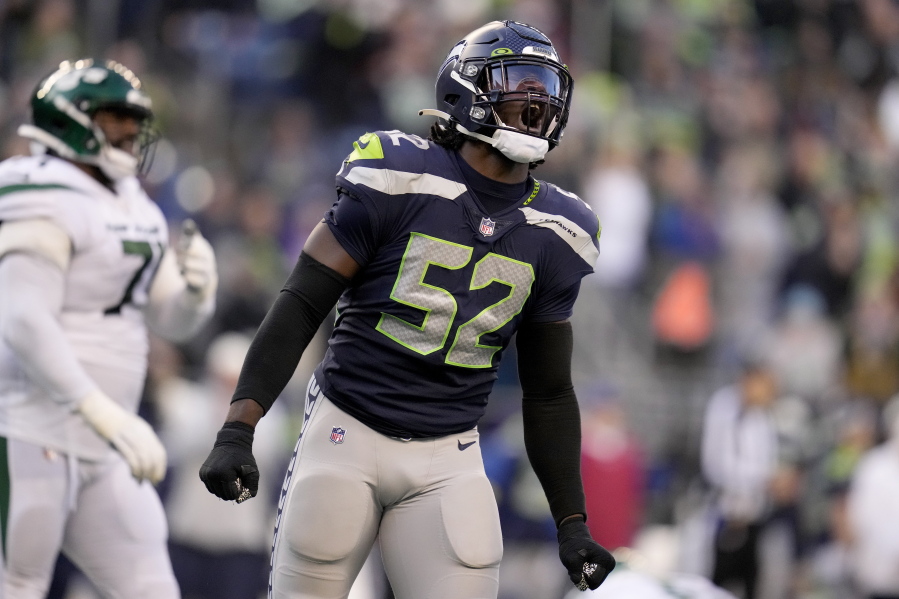 Seattle Seahawks defensive end Darrell Taylor (52) celebrates a defensive stop against the -n- during the second half of an NFL football game, Sunday, Jan. 1, 2023, in Seattle. (AP Photo/Godofredo A.