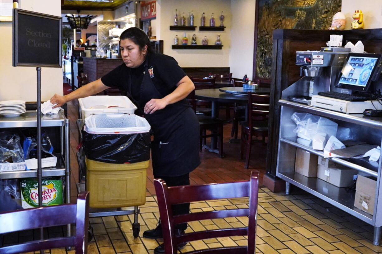 A waitress works at a restaurant in Chicago, Thursday, Jan. 5, 2023. America's employers added a solid 223,000 jobs in December, evidence that the economy remains healthy yet also a sign that the Federal Reserve may still have to raise interest rates aggressively to slow growth and cool inflation.  (AP Photo/Nam Y.