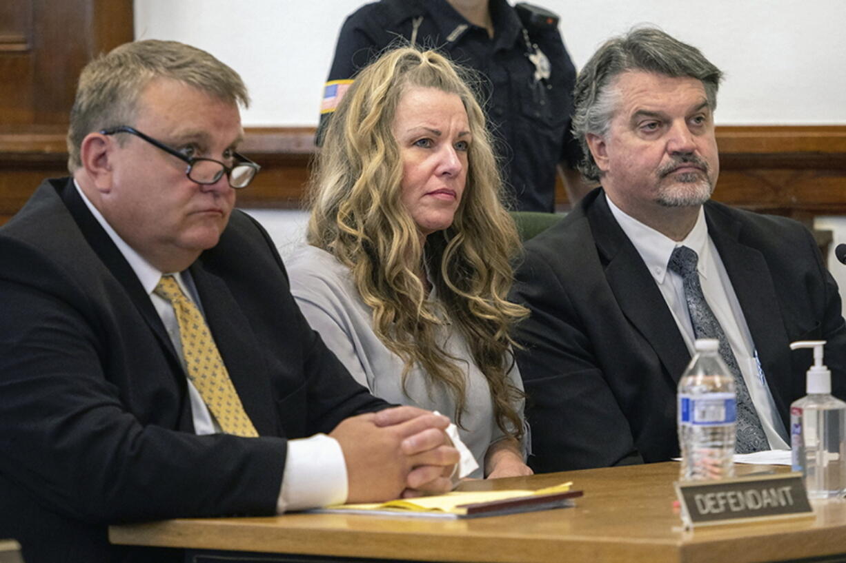 FILE - Lori Vallow Daybell, center, sits between her attorneys for a hearing at the Fremont County Courthouse in St. Anthony, Idaho, on Aug. 16, 2022. An Idaho judge says a couple accused in a bizarre triple murder case will not be allowed to meet face-to-face to talk about strategy before they stand trial in April 2023. EastIdahoNews.com reports attorneys for Lori Vallow Daybell and Chad Daybell presented several requests to 7th District Judge Steven Boyce during a motion hearing on Thursday, Jan. 19, 2023.